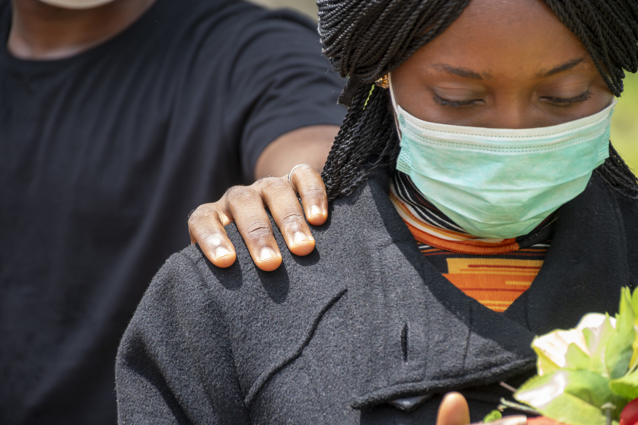 african female at a funeral with face mask